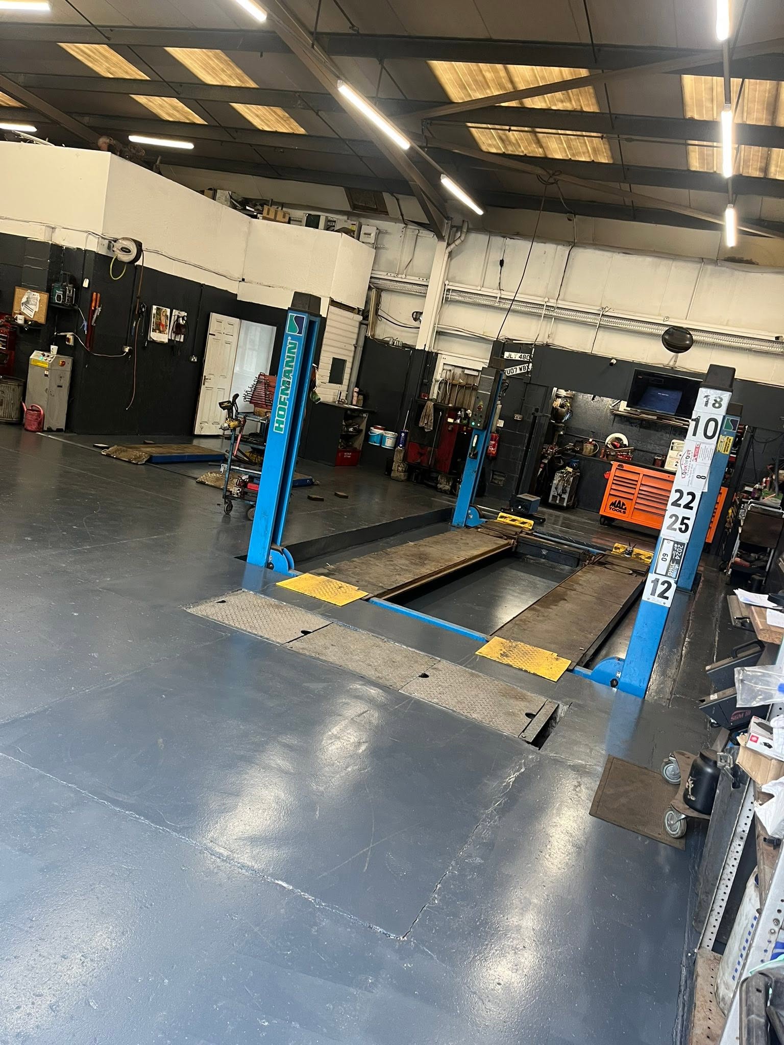 A four-post lift bay inside the Morris Autos workshop