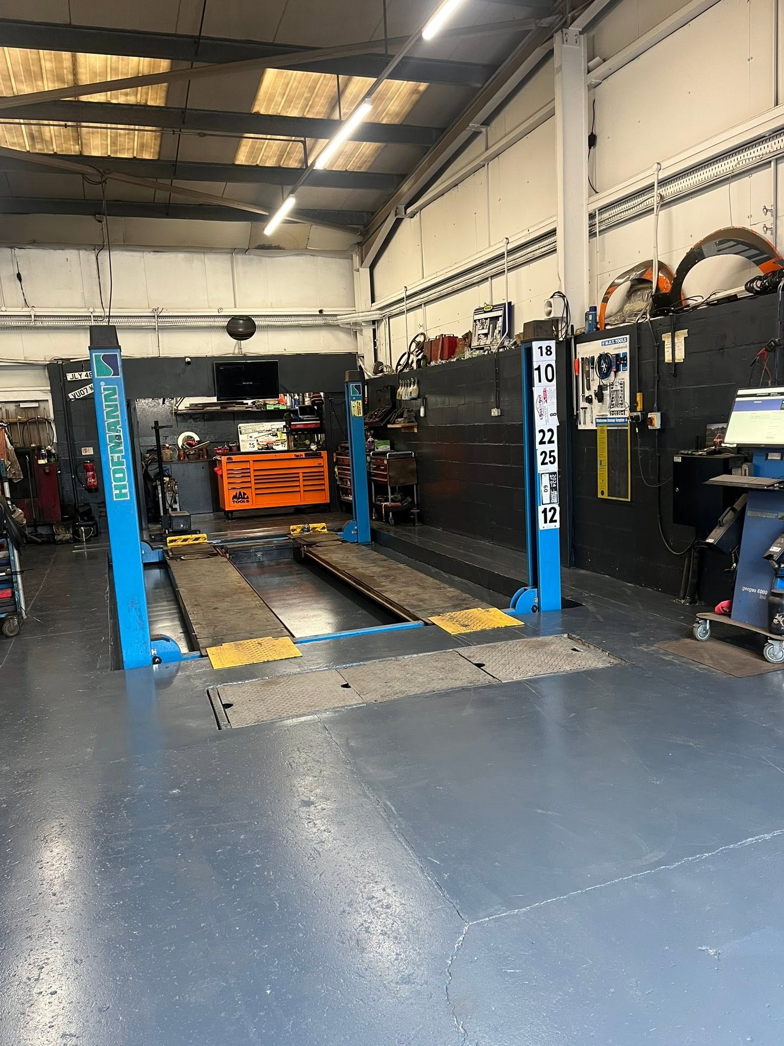 Four-post lift bay with a tool chest behind it