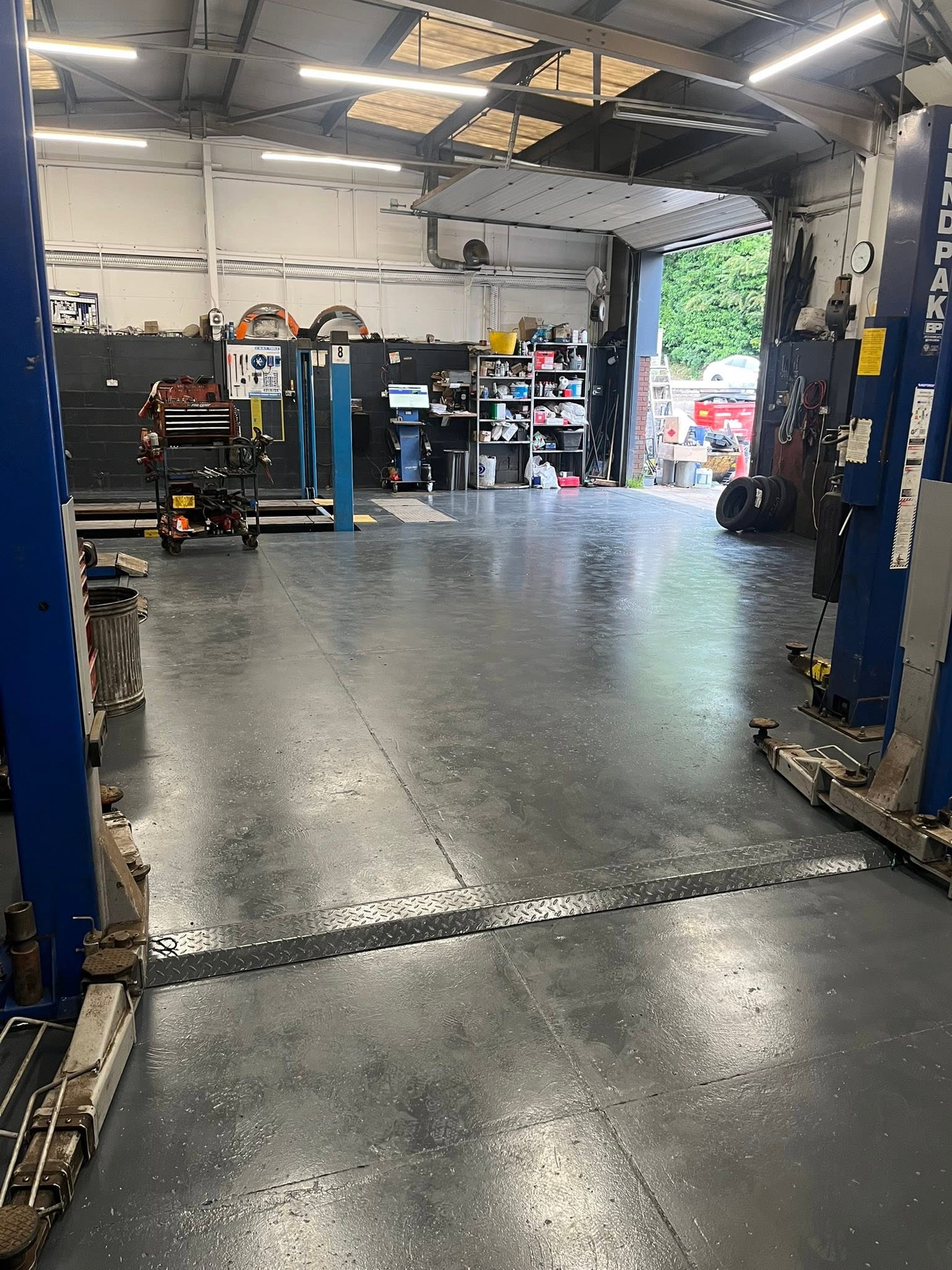 Workshop floor between two lifts with the roller door open