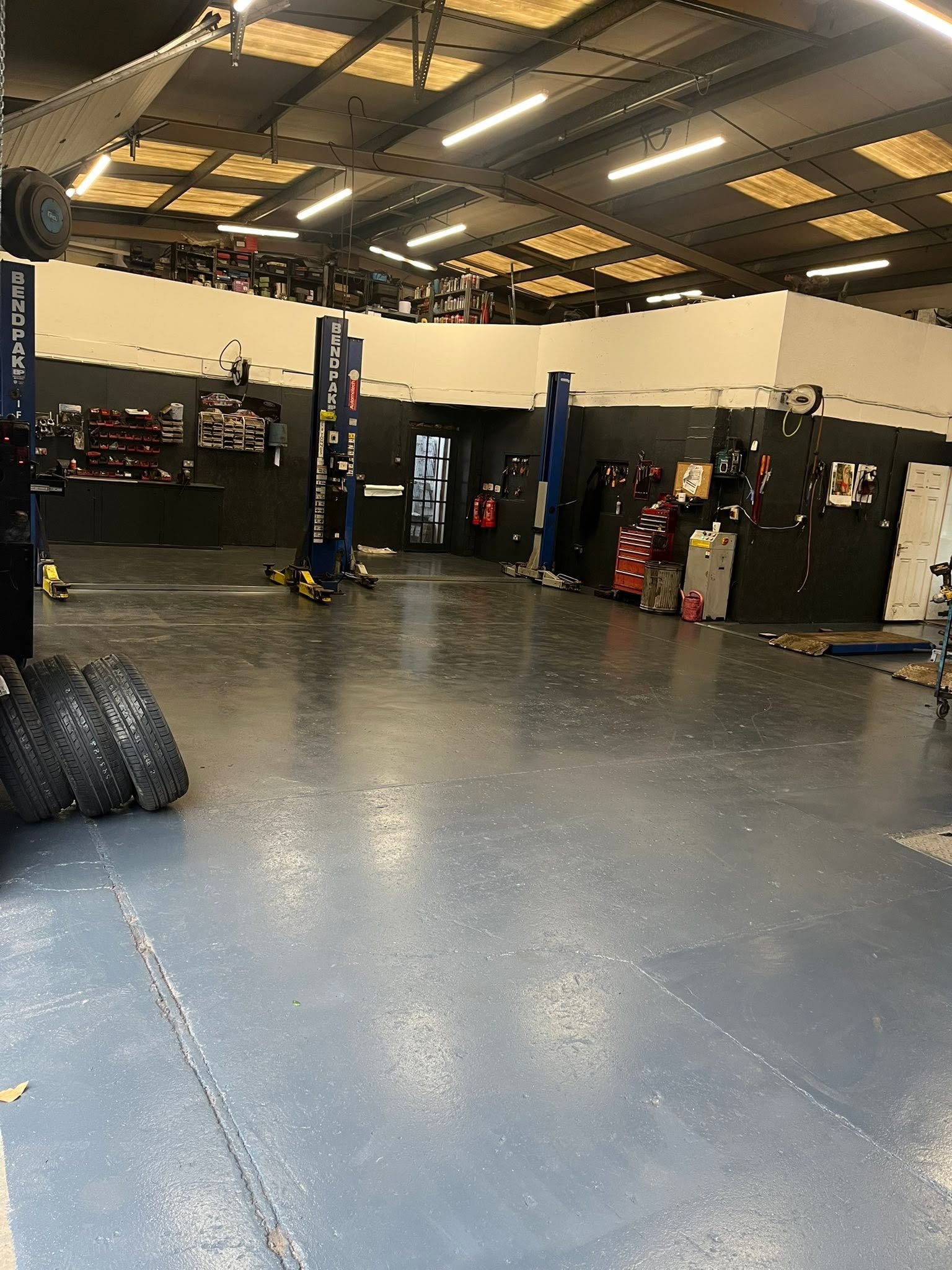 Wide view of the workshop, lifts and tyres