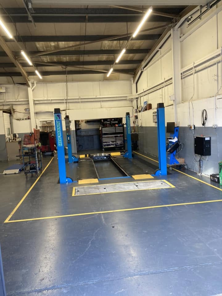 A four-post lift bay marked out in yellow